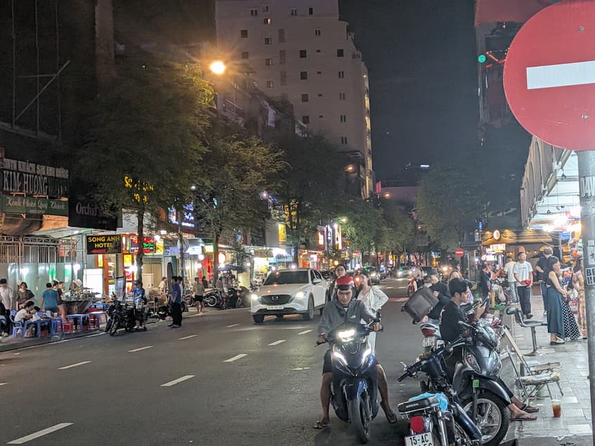 ホーチミンの夜の飲食街。ネオンの灯る通りに飲食店が並ぶ