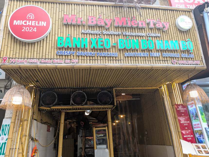 Mr. Bảy Miền Tâyの外観。竹の看板にMICHELIN 2024のロゴと住所79 Hàng Điếu、右に2024・2025・2026のバナーが並ぶ