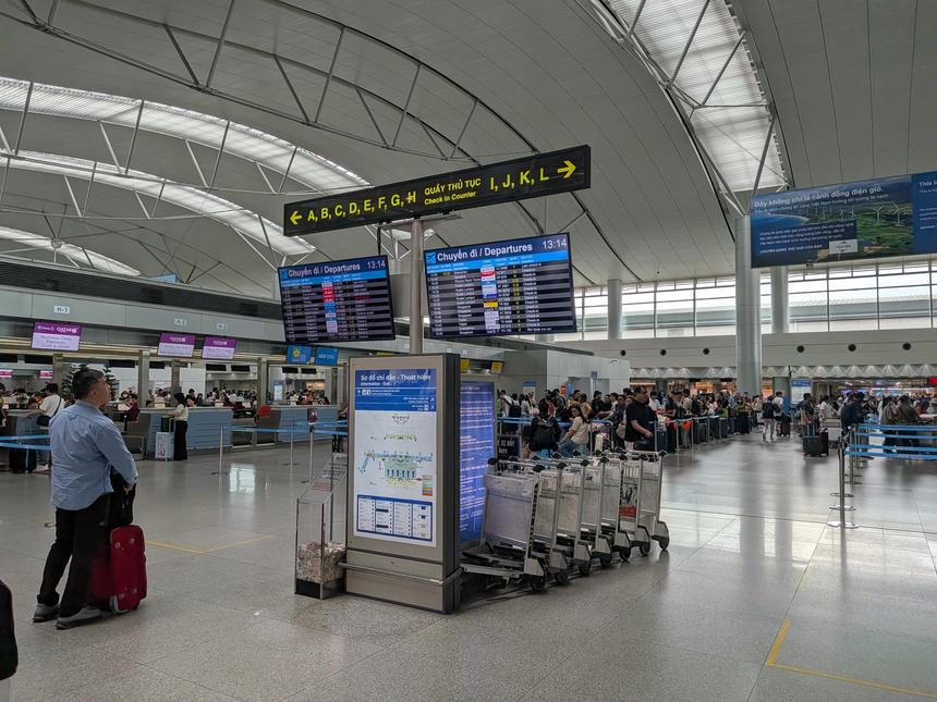 ホーチミンのタンソンニャット国際空港の国際線出発ホール。チェックインカウンターの案内サインと出発便の掲示板が並ぶ。日本からホーチミンへの直行便は成田から約6時間半。