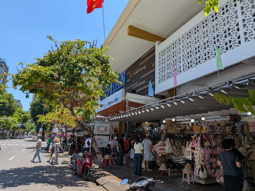 ハン市場の正面入口。CHO HANの看板の下にかごバッグや麦わら帽子の露店が並ぶ