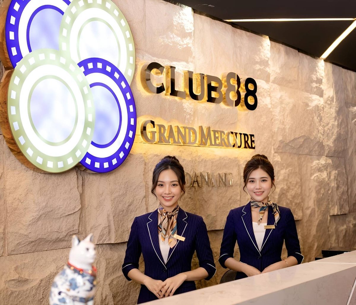 Friendly staff welcoming guests at the reception of Club 88 casino in the Grand Mercure Danang.