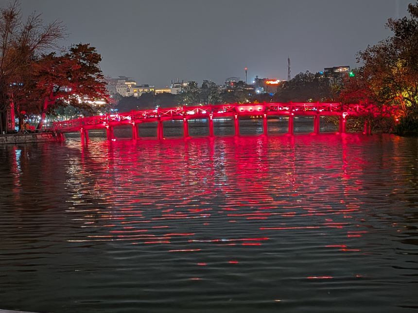 2026年4月4日夜のホアンキエム湖。赤くライトアップされたテフック橋が湖面に映っている